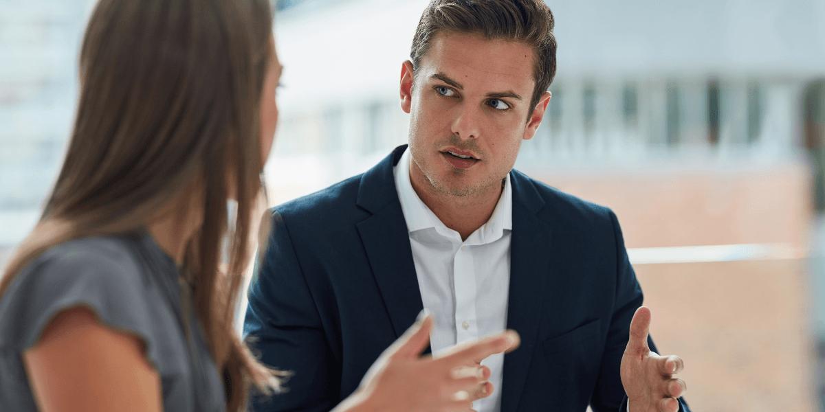 Två kollegor i samtal på kontor, illustration av psykologisk trygghet och öppen dialog.